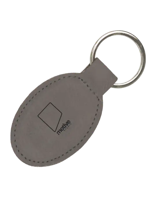Grey Leatherette Oval Keychain w/Motive Studio Logo