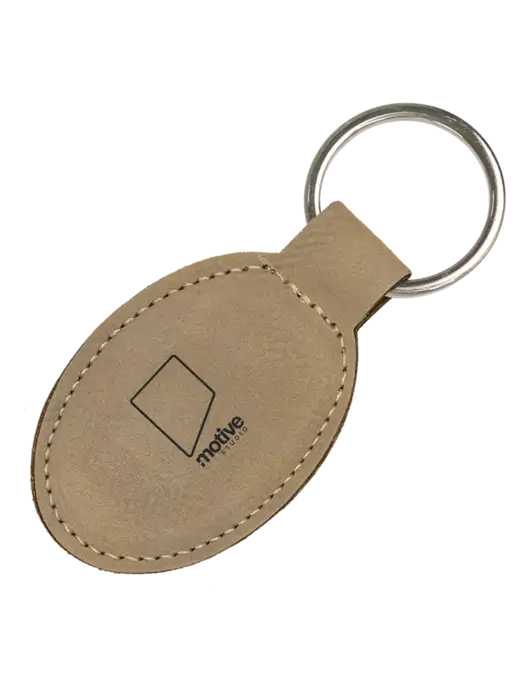 Tan Leatherette Oval Keychain w/Motive Studio Logo